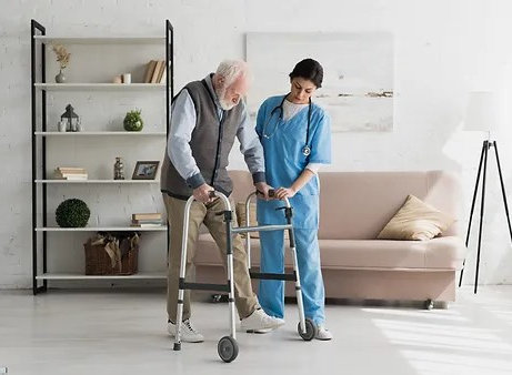 Nurse helping to senior man walking