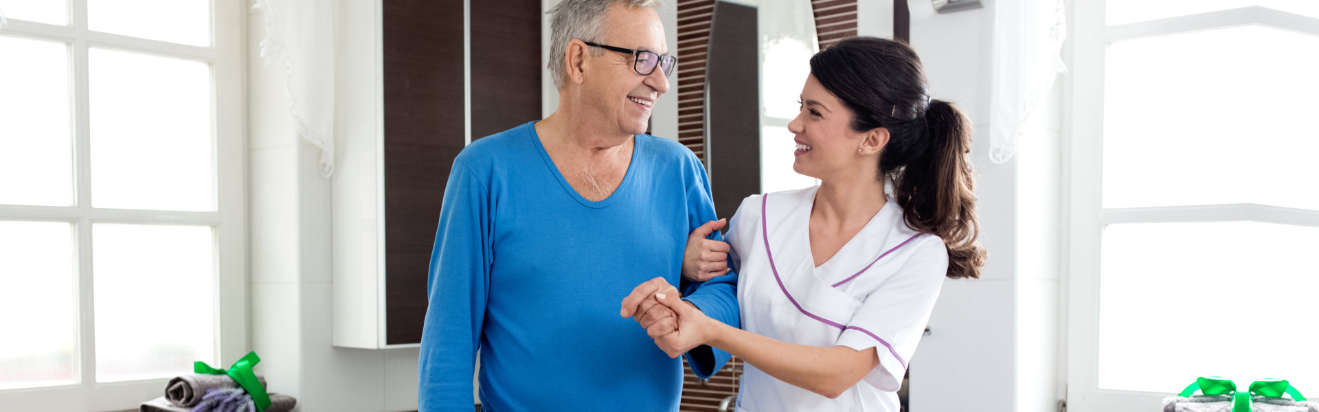 woman helping elderly man